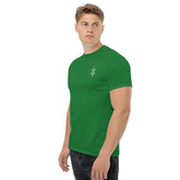 man wearing green classic tee standing against white background