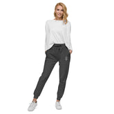 Women fleece sweatpants in charcoal heather with cuffed legs and elastic waistband worn with white top and sneakers