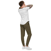 Men fleece sweatpants in olive green with cuffed legs and elastic waistband worn with white sneakers and t-shirt