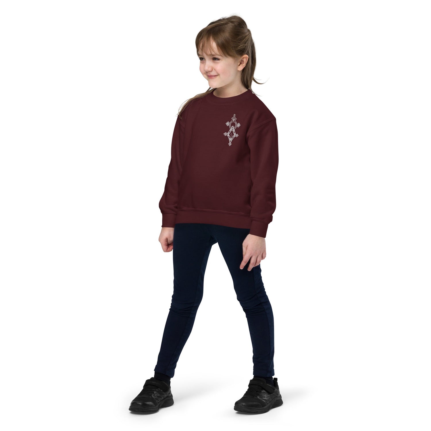 Youth crewneck sweatshirt in maroon worn by child with geometric design on chest