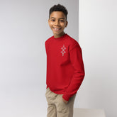 Youth crewneck sweatshirt in red fleece worn by smiling boy with hands in pockets