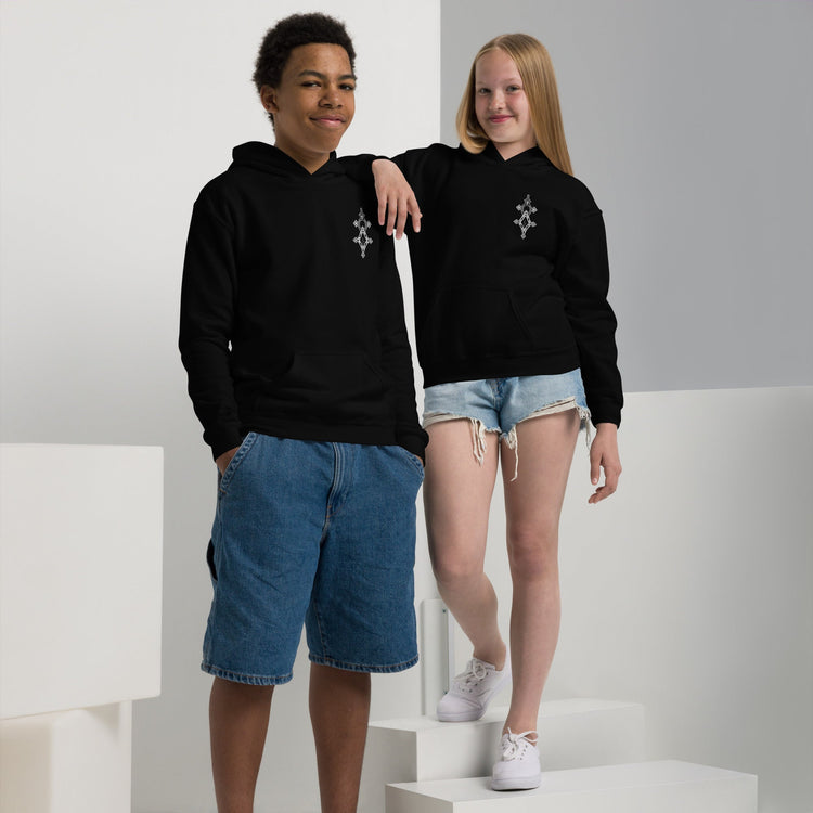 youth heavy blend hoodie in black worn by boy and girl with front pouch pocket and double-lined hood