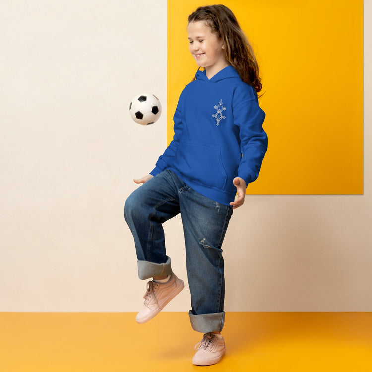 Child wearing blue youth heavy blend hoodie playing with soccer ball indoors