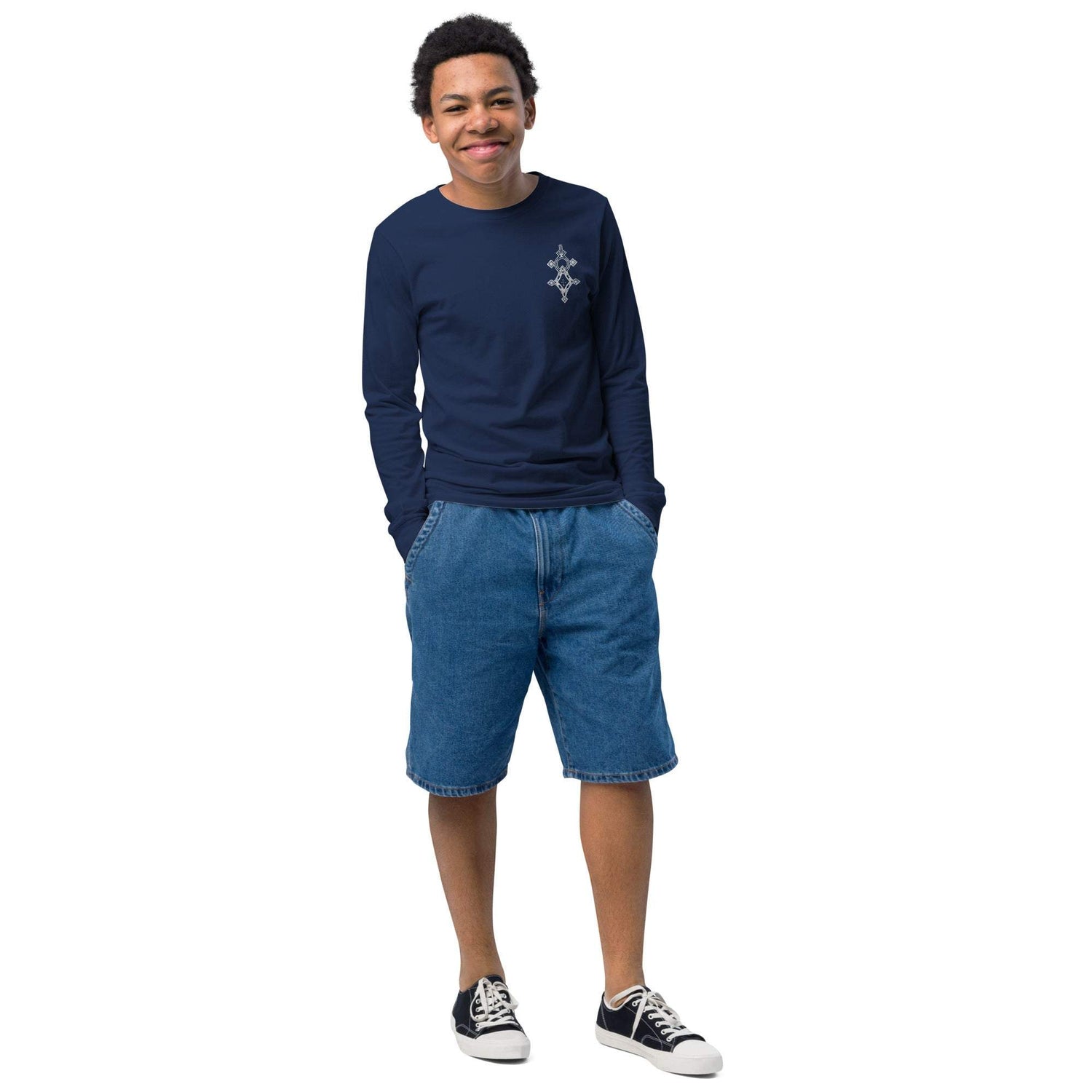 Youth long sleeve tee made of soft Airlume cotton with ribbed cuffs and classic crew neck worn by smiling boy in denim shorts