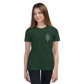 Youth short sleeve t-shirt in dark green with a small front print, worn by a young girl with relaxed unisex fit.